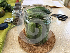 A jar of cucumbers is on the table