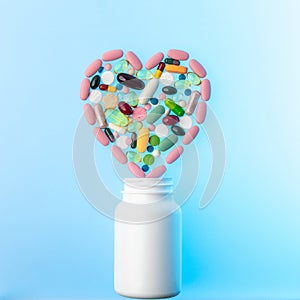 Jar of different tablets and pills in shape of heart on top of it. Multi-colored pills in the shape of heart on. Concept