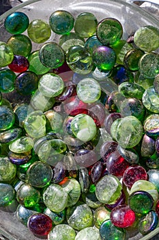 Jar of dusty colorful glass beads for plant decoration