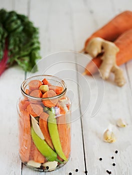 Jar with fermented peppers carrots, garlic and ginger. Harvesting, Canned Vegetarian Food, Concepts. Cabbage, dill, carrots,