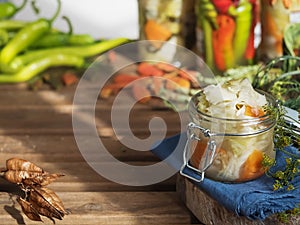 Jar with fermented vegetables. Fermented, canned vegetarian food concept. Cabbage, dill, carrots, green peppers. Sauerkraut in a