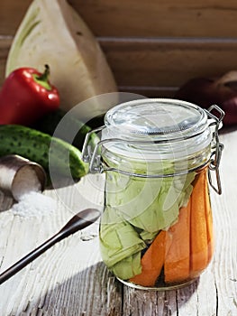 Jar with fermented vegetables. Fermented, canned vegetarian food concept. Cabbage, dill, markov. Sauerkraut in a glass jar on a