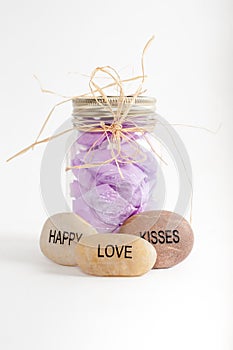 Jar of flower petals with happy, love and kisses rocks