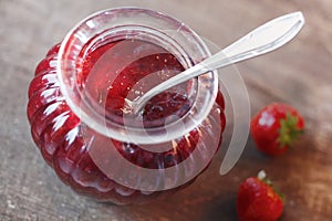 Jar of fresh homemade strawberry preserve photo