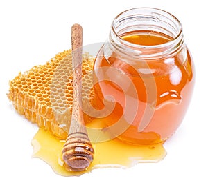 Jar full of fresh honey and honeycombs.