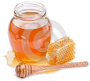 Jar full of fresh honey and honeycombs.