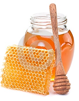 Jar full of fresh honey and honeycombs.