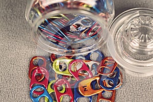 Jar full of multi colored can pull tabs