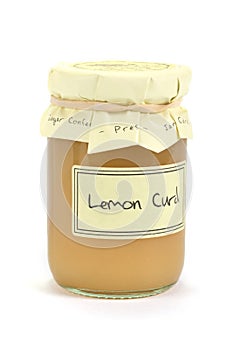 Jar of home made lemon curd on white