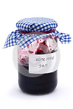 Jar of homemade jam over white