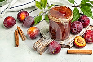 Jar with homemade plum jam on a wooden background. banner, menu, recipe place for text