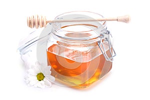 Jar of honey , dipper and flower