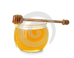 Jar of honey with dipper on white background