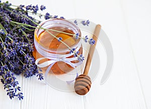 Jar with honey and fresh lavender flowers
