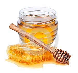 Jar with honey, honeycomb and wooden honey dipper isolated on white background