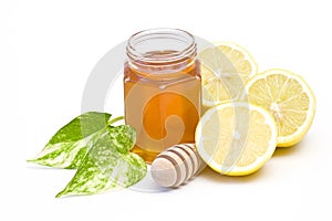 Jar of honey, lemon and wooden drizzler