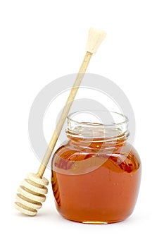 Jar of honey and wooden dripper