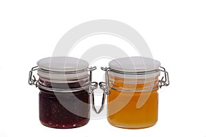 Jar of jam and honey on white background