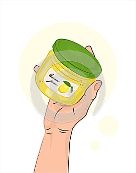 A jar of lemon jam. Jam from lemon. A jar in a human hand. Healthy food.