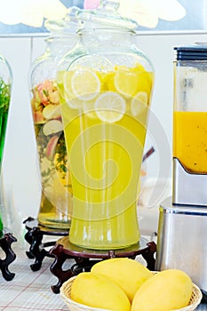 Jar of lemonade. fresh sliced lemons. Ice cold useful juicy beverage. Refreshing drink during Summer time