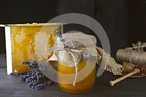 Jar of liquid honey with honeycomb