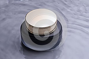 Jar of luxury face cream in a water. Cosmetic mockup. beauty product and skincare, cosmetic science concept