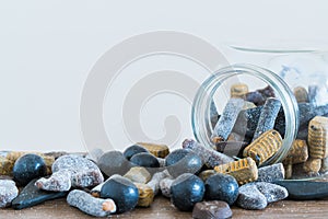 Jar lying on side with salmiakki spilling out onto table