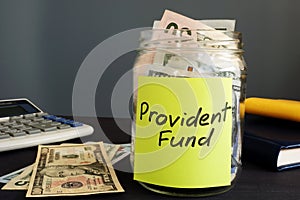 Jar with money and label Provident fund PF. photo