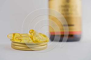 Jar with omega 3 capsules in a cap on a white background