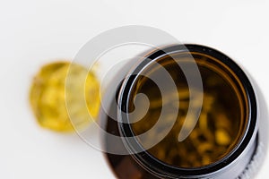 Jar with omega 3 capsules in a cap on a white background