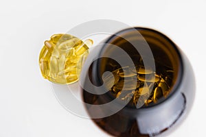 Jar with omega 3 capsules in a cap on a white background