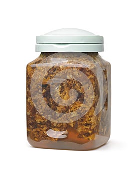 Jar of organic bees comb capping mixed with raw honey, propolis and pollen