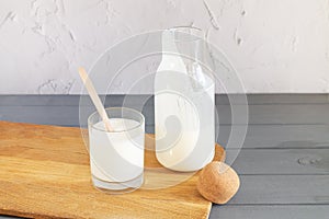 Jar of organic yogurt or kefir with glass and spoon