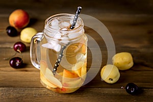 Jar of Peach Ice Tea with Fresh Fruits on a Rustic Wooden Background Tasty Fresh Summer Drink