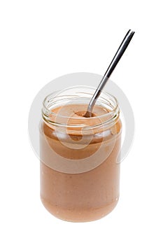 Jar of peanut butter with spoon isolated