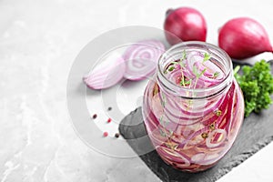 Jar of pickled onions on marble table