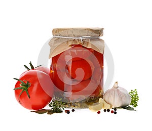 Jar of pickled tomatoes and fresh ingredients on white background