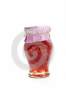 Jar of rose jam isolated on white background. Homemade jam of rose petals