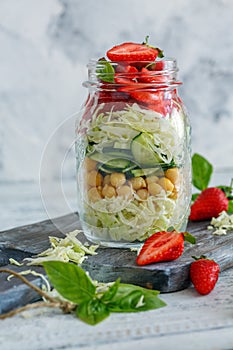 Salad with strawberries and chickpeas in a jar.