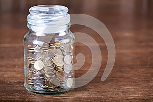 Jar savings spare change concept dark background.