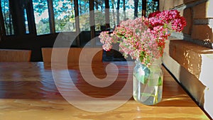 Jar of Sedum Pink Flowers on Table