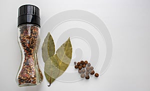 A jar of spices, Bay leaf on a white background in the kitchen