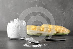 Jar and spoon with corn starch on table