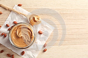 Jar and spoon with creamy peanut butter