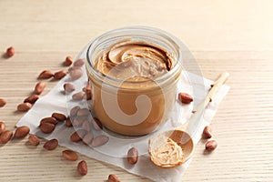 Jar and spoon with creamy peanut butter