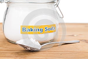 Jar and spoonful of baking soda for multiple holistic usages