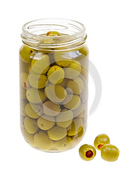 A jar of stuffed green olives isolated