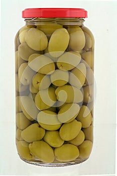 A jar of stuffed green olives isolated