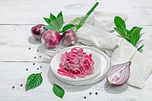 Jar with tasty pickled onions on black table. Cutlery, served meal ready to eat, trendy stand