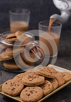 Cutting chai with biscuits and kettle photo